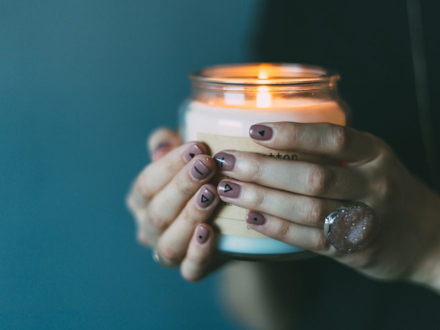 person holding white candle with light