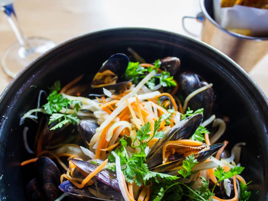 shallow focus photo of mussel dish on black pot
